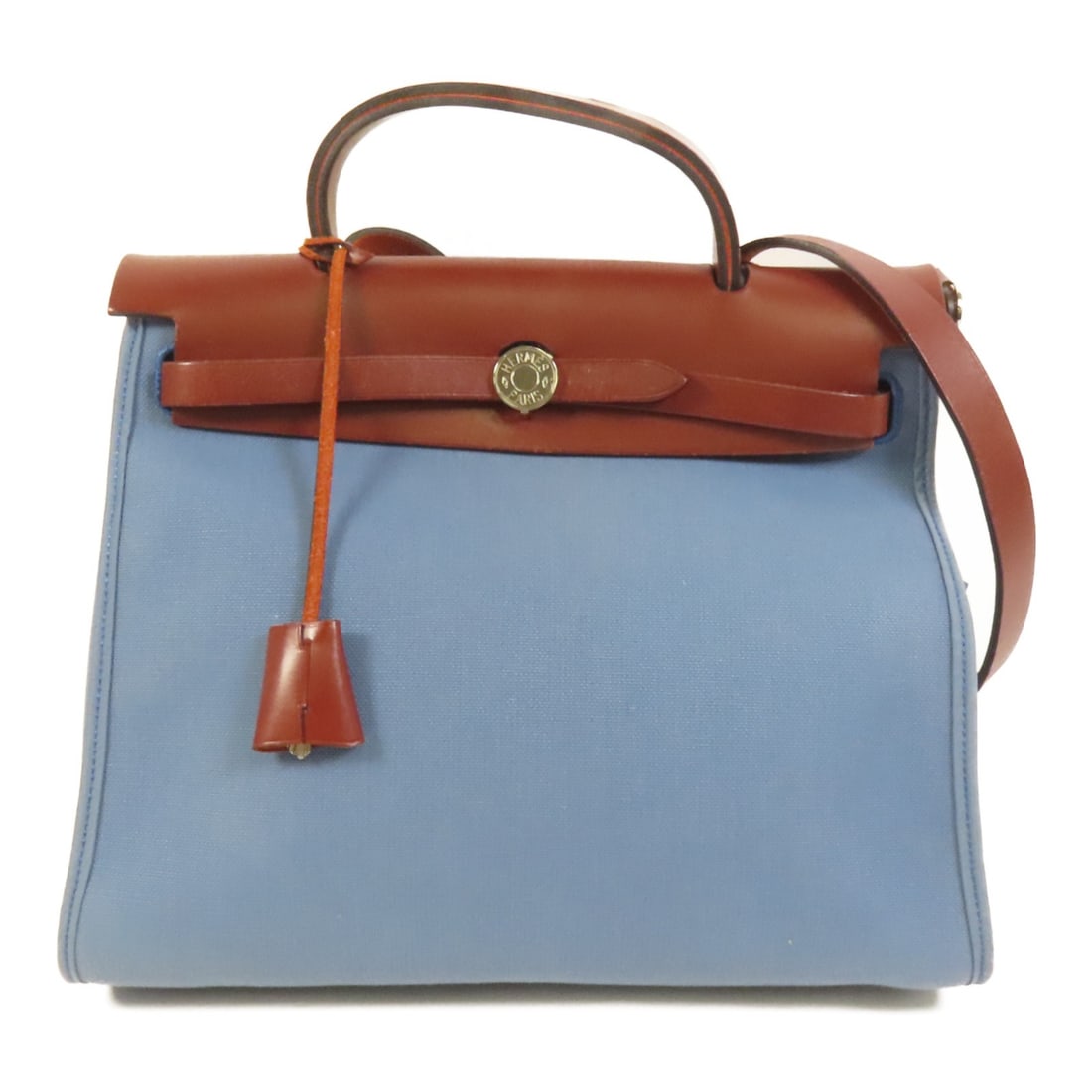 HerBag PM Blue Canvas Shoulder Handbag with Palladium Hardware: HerBag PM Blue Canvas Shoulder Handbag with Palladium Hardware This Hermes HerBag PM is a versatile 2-way shoulder bag crafted from durable blue canvas. Designed for women, it features a structured si