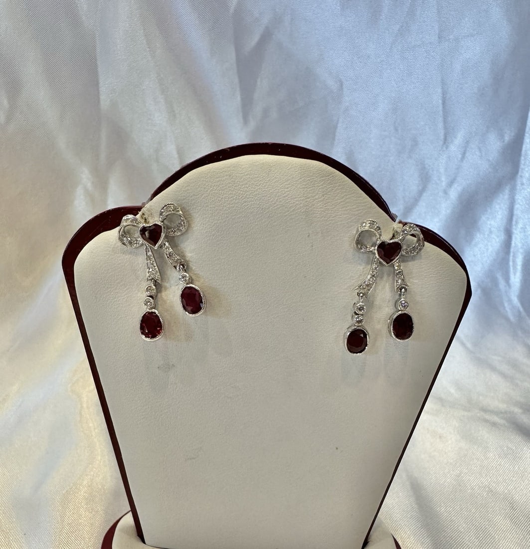 French Platinum 18k White Gold Ruby Diamond Dangle Earrings: French Platinum 18k White Gold Ruby Diamond Dangle Earrings Elevate your elegance with this exquisite pair of French earrings crafted from platinum and 18k white gold. Each earring features a stunning