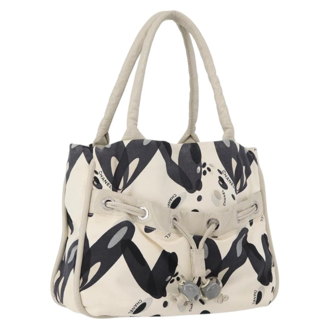 White and Silver Canvas Tote by CHANEL with CC Logo: White and Silver Canvas Tote by CHANEL with CC Logo This CHANEL tote bag is crafted from white and silver canvas, offering a stylish and versatile accessory for women. Made in Italy, the bag features