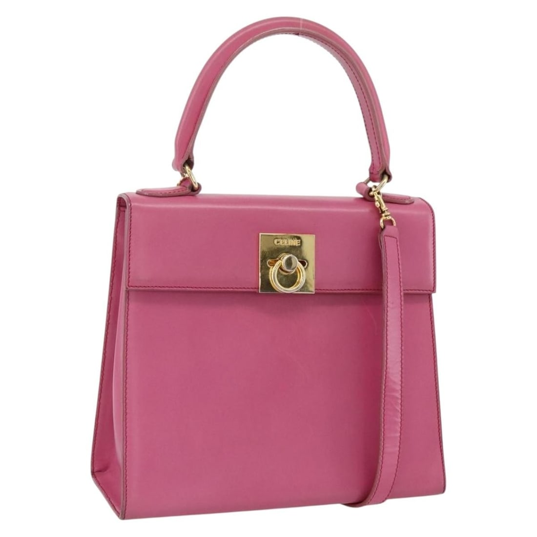 Celine Pink Leather Two Way Handbag with Gold Accents and Shoulder Strap: Celine Pink Leather Two Way Handbag with Gold Accents and Shoulder Strap This CELINE 2-way handbag is crafted from leather in a pink and gold color combination. Designed for women, it features both a