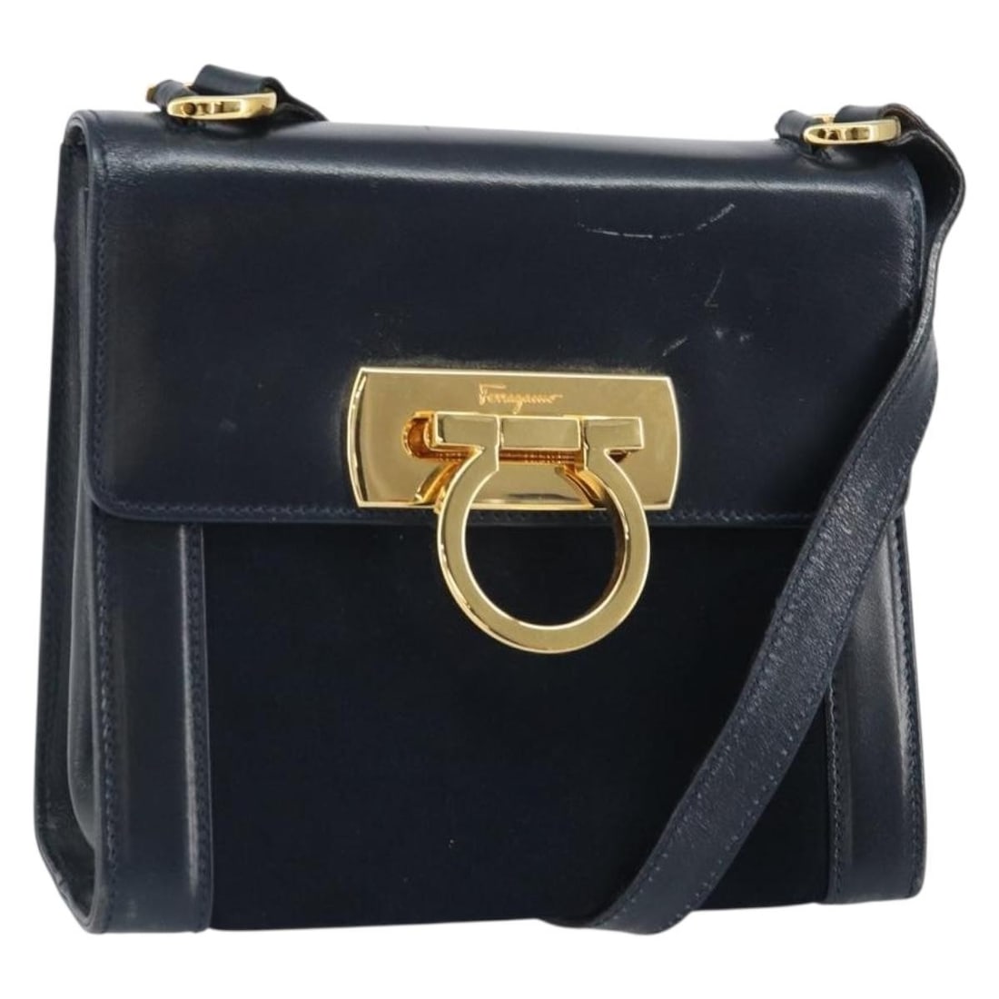 Navy Leather Gancini Shoulder Bag by Salvatore Ferragamo Gold Tone Hardware: Navy Leather Gancini Shoulder Bag by Salvatore Ferragamo Gold Tone Hardware This Salvatore Ferragamo Gancini Shoulder Bag is crafted from navy leather with gold-tone accents. The compact silhouette fe