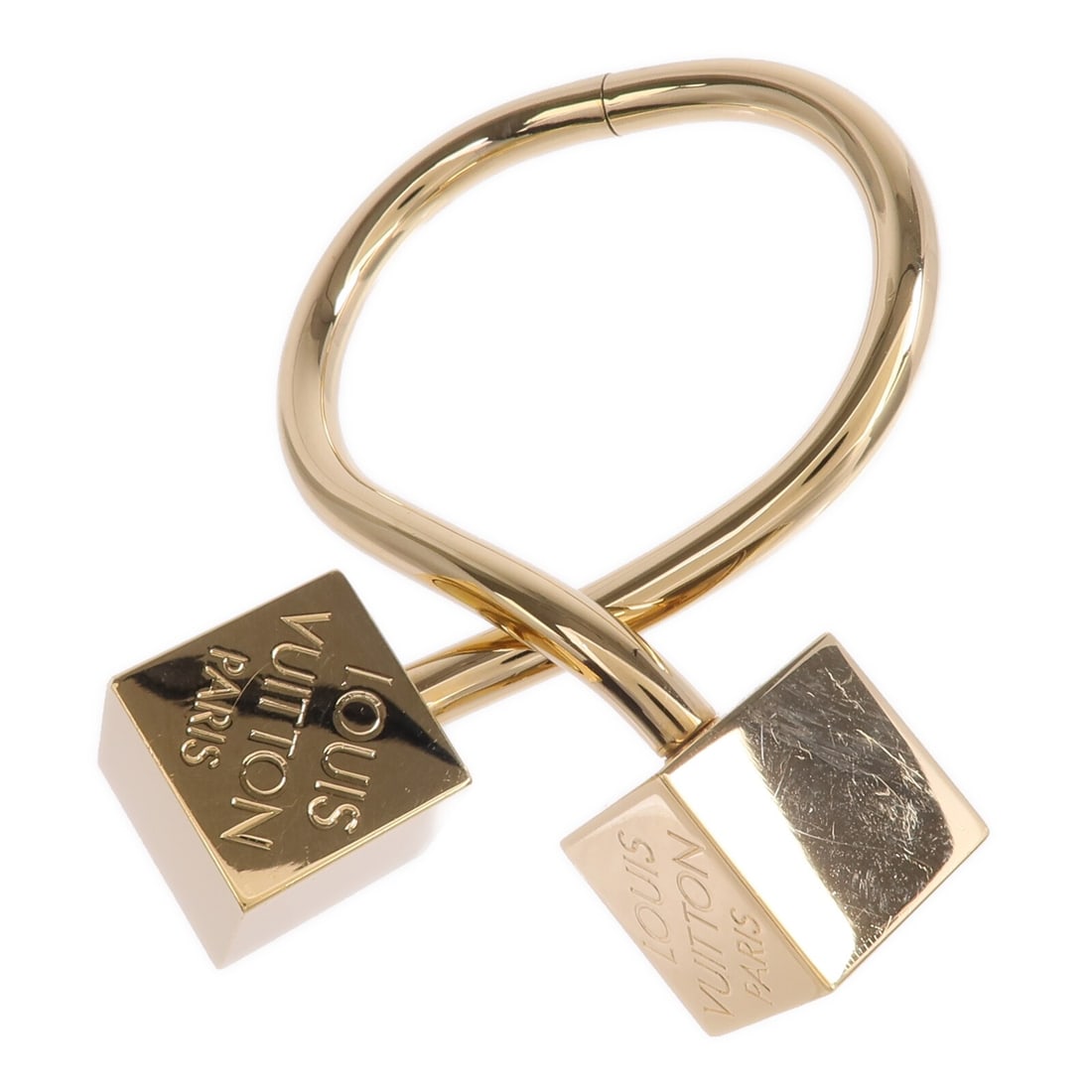 Louis Vuitton Gold Tone Cube Metal Bracelet for Women: Louis Vuitton Gold Tone Cube Metal Bracelet for Women This Louis Vuitton LV Cube cuff bracelet features a gold-tone metal design, crafted for women. The bracelet does not include any stones and is mad