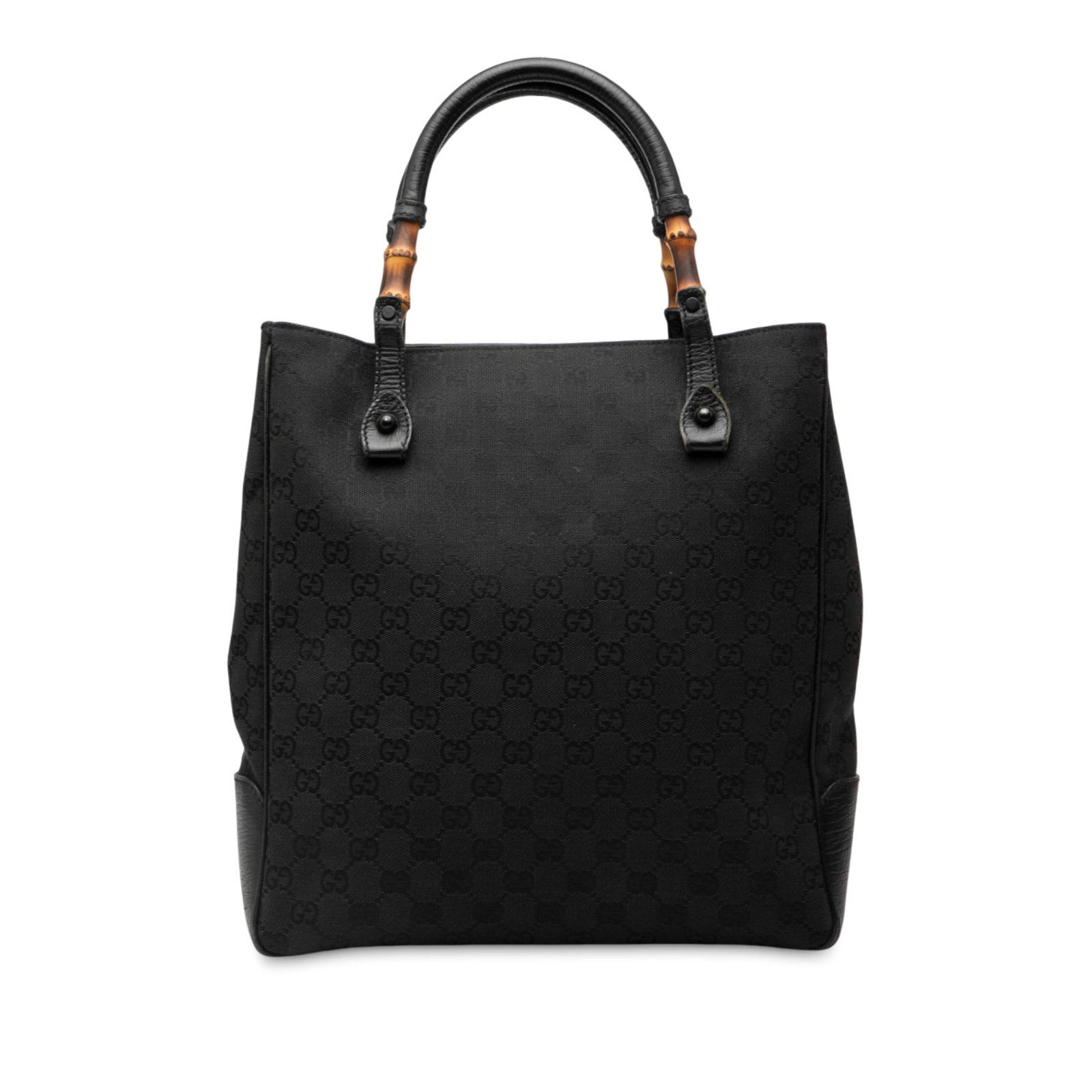 Black GG Canvas Bamboo Detail Tote Bag by Gucci: Black GG Canvas Bamboo Detail Tote Bag by Gucci This Gucci GG Canvas Bamboo Tote features a black canvas exterior with leather trim and distinctive rolled leather handles accented with bamboo details.