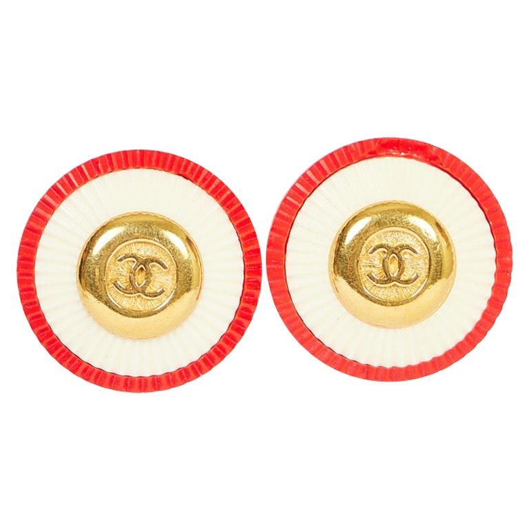 Vintage Chanel 70s Red White Clip Earrings with CC Logo: Vintage Chanel 70s Red White Clip Earrings with CC Logo Discover the elegance of these vintage Chanel clip earrings from the 1970s, featuring a striking red and white design. These rare earrings are l