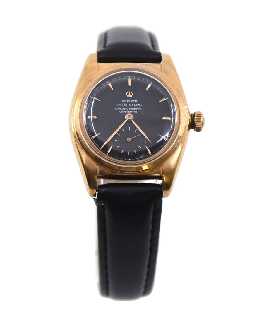 Rolex Oyster Perpetual Bubbleback 18K Rose Gold Watch Ref 5052: Rolex Oyster Perpetual Bubbleback 18K Rose Gold Watch Ref 5052 This exquisite Rolex Oyster Perpetual Bubbleback watch features a stunning 18K rose gold case and a classic black dial, embodying timeles