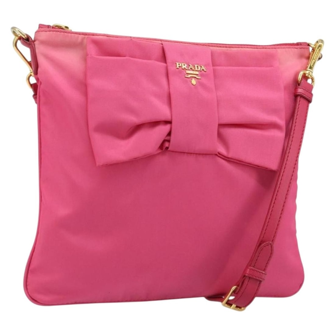 Pink Nylon Prada Ribbon Shoulder Bag with Gold Details for Women: Pink Nylon Prada Ribbon Shoulder Bag with Gold Details for Women This PRADA Ribbon shoulder bag features a pink and gold nylon exterior, offering a stylish and lightweight option for women. The bag is