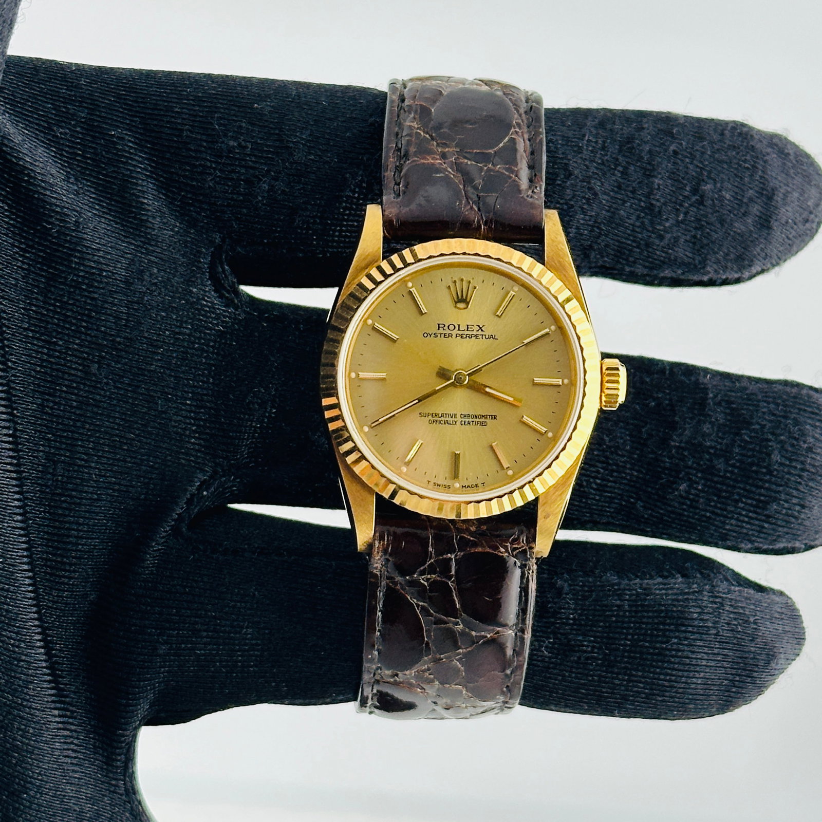 Ladies Oyster Perpetual Watch Champagne Stick Dial Ref 67518 on Leather: Ladies Oyster Perpetual Watch Champagne Stick Dial Ref 67518 on Leather This ladies' Rolex Oyster Perpetual features a champagne stick dial and a fluted bezel, complemented by an aftermarket leather b