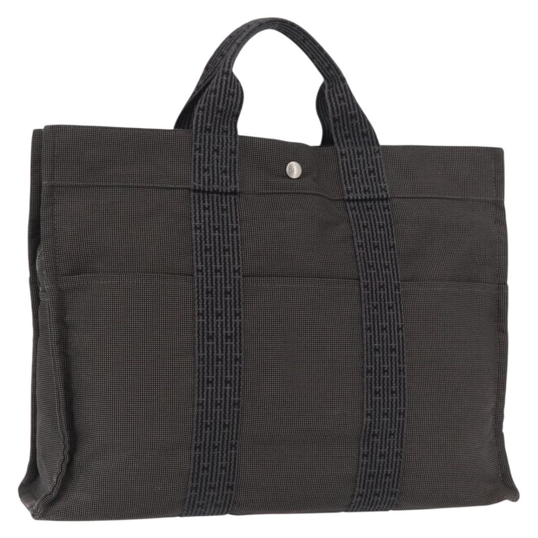 Hermes Her Line MM Gray Canvas Tote Handbag Silver Hardware: Hermes Her Line MM Gray Canvas Tote Handbag Silver Hardware This Hermes Her Line MM handbag is crafted from durable gray and silver canvas. Designed for women, it features a spacious interior with a p