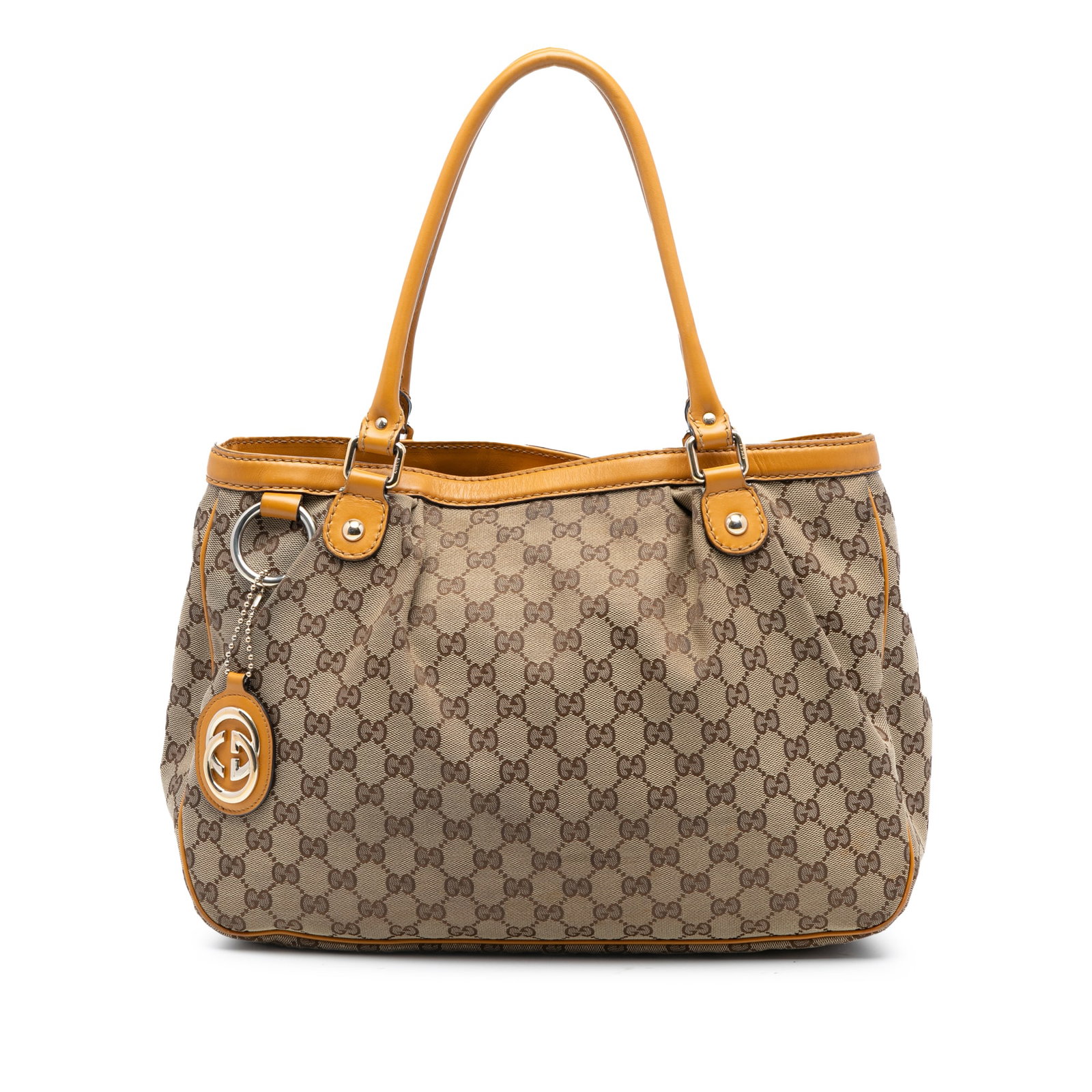 Gucci Sukey Tote Bag in GG Canvas with Leather Trim: Gucci Sukey Tote Bag in GG Canvas with Leather Trim The Gucci GG Canvas Sukey Tote features a beige canvas body with leather trim, rolled leather handles, and an open top secured by a magnetic snap cl