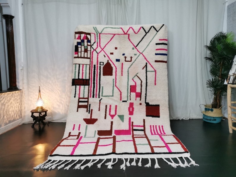 Authentic Moroccan Berber Wool Rug Handwoven in White 10 x 5 Feet: Authentic Moroccan Berber Wool Rug Handwoven in White 10 x 5 Feet Enhance your living space with this stunning, handwoven Moroccan Berber rug. Crafted by local Berber women weavers in the Middle Atlas