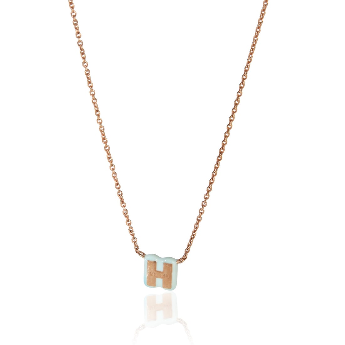 14K Rose Gold Pendant With Baby Blue Enamel Mini H Initial: 14K Rose Gold Pendant With Baby Blue Enamel Mini H Initial This women's pendant features a mini initial 'H' design in baby blue enamel and is crafted from 14K rose gold. The piece is pre-owned and com