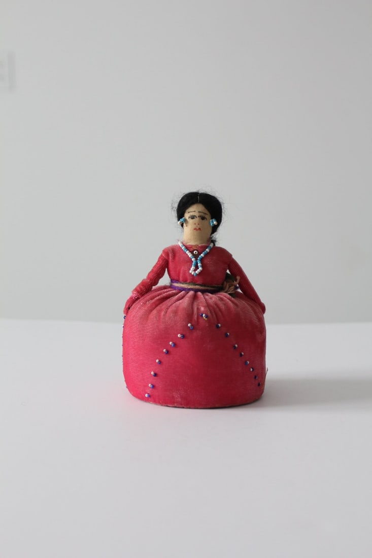 Vintage Navajo Doll Pin Cushion Pink Velvet Decorative Piece: Vintage Navajo Doll Pin Cushion Pink Velvet Decorative Piece This charming Vintage Native American doll pin cushion showcases a beautifully crafted design. It features a vibrant pink velvet dress ador