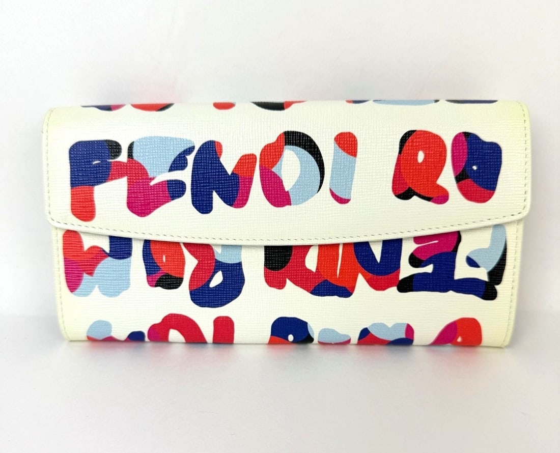 Fendi Roma Graffiti Multicolor Leather Long Snap Wallet: Fendi Roma Graffiti Multicolor Leather Long Snap Wallet This Fendi wallet features a multicolor graffiti pattern on white Vitello Elite leather with canvas fabric details. Designed for women, it has a