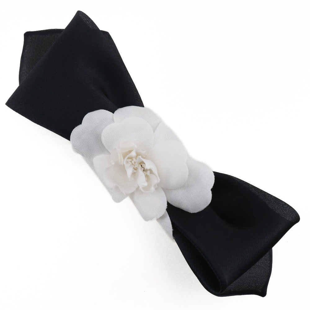 Chanel Satin Camellia Ribbon Headband Black 20cm: Chanel Satin Camellia Ribbon Headband Black 20cm This Chanel Camellia Ribbon Headband is crafted from black satin, designed for women. It features a length of 20 cm and originates from France. The hea