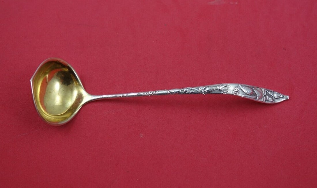 Tiffany & Co. Vine Sterling Silver Sauce Ladle with Gold-Washed Bowl: Tiffany & Co. Vine Sterling Silver Sauce Ladle with Gold-Washed Bowl This exquisite ladle from the Vine pattern by Tiffany & Co. showcases the elegance of sterling silver craftsmanship. Crafted betwee