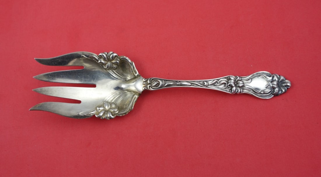 Frank Whiting Lily Sterling Silver Salad Serving Fork 9": Frank Whiting Lily Sterling Silver Salad Serving Fork 9" This exquisite salad serving fork is crafted from sterling silver and features the elegant 'Lily' pattern by Frank Whiting. Measuring 9 inches,
