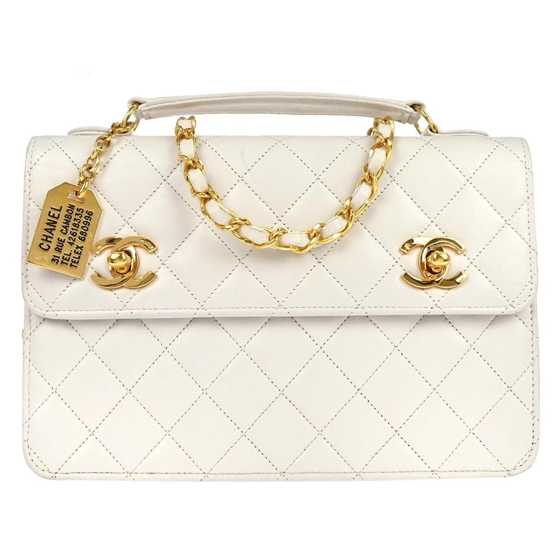 Chanel Lambskin Medium Top Handle Bag in White Leather with Double Turnlock: Chanel Lambskin Medium Top Handle Bag in White Leather with Double Turnlock This Chanel handbag features white lambskin leather and a double turnlock closure. Designed in a medium size, it offers a cl