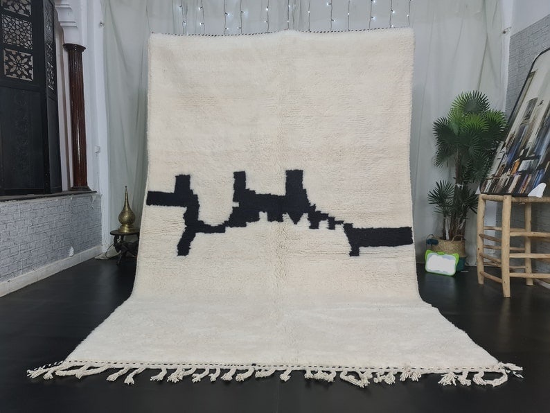 Handmade Moroccan Berber Wool Rug 10 x 5 Feet: Handmade Moroccan Berber Wool Rug 10 x 5 Feet Experience the elegance and comfort of this Soft White & Black Handmade Moroccan Berber Wool Rug. Crafted by skilled Berber women weavers in the Middle At
