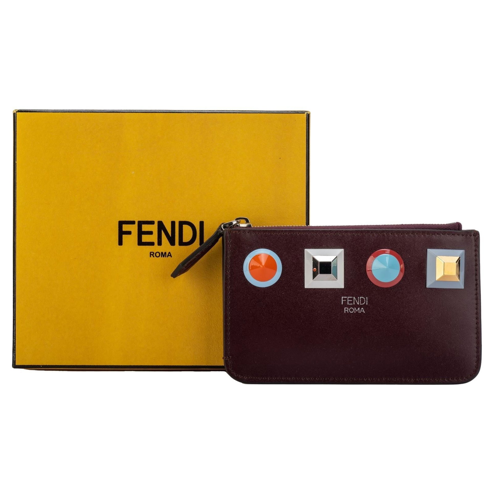 Fendi Burgundy Zipped Wallet with Colorful Studs New in Box: Fendi Burgundy Zipped Wallet with Colorful Studs New in Box Introducing a stunning Fendi zipped wallet in a rich burgundy hue, crafted from premium leather. This stylish key case features vibrant colo
