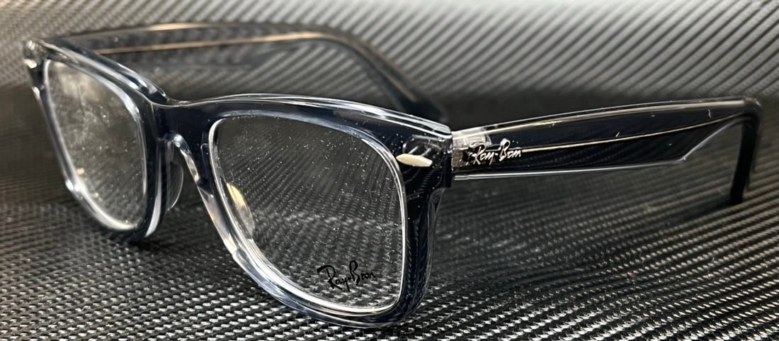 RAY BAN RX4340V 8225 Transparent Grey Unisex Eyeglasses 50mm with Case: RAY BAN RX4340V 8225 Transparent Grey Unisex Eyeglasses 50mm with Case Discover style and comfort with the RAY BAN RX4340V 8225 eyeglasses, designed for unisex wear. These frames feature a modern tran