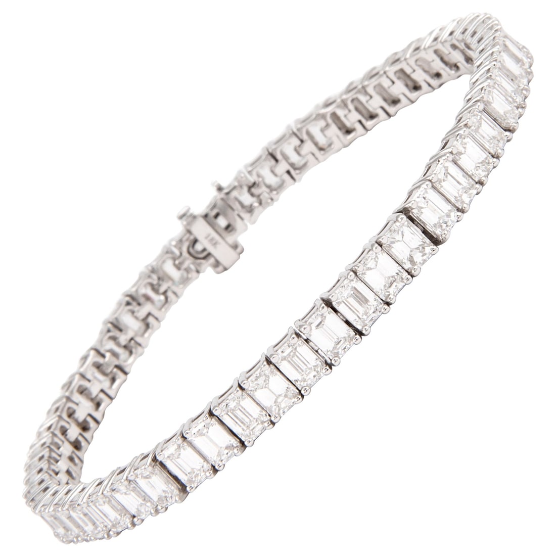 12.65 Carat Emerald Cut Diamond Tennis Bracelet 18K White Gold: 12.65 Carat Emerald Cut Diamond Tennis Bracelet 18K White Gold This exquisite tennis bracelet features a stunning assembly of 52 emerald cut diamonds, totaling 12.65 carats, set in luxurious 18-karat