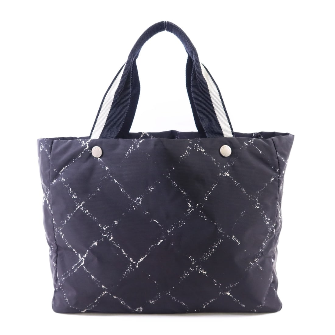 Black Nylon Travel Tote CHANEL CC Silver Hardware: Black Nylon Travel Tote CHANEL CC Silver Hardware This CHANEL Travel Line tote bag features a black nylon exterior with the signature CC logo and silver tone hardware. Designed for versatility and eve