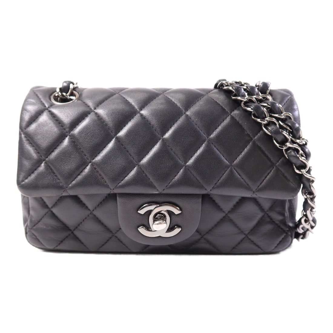 Chanel Mini Classic Black Lambskin Shoulder Bag Silver Chain A69900: Chanel Mini Classic Black Lambskin Shoulder Bag Silver Chain A69900 This CHANEL Mini Classic 20 chain shoulder bag features a sleek black lambskin leather exterior and silver-tone CC hardware. Designe