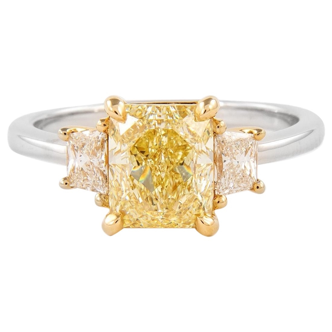 2.01ct GIA Fancy Yellow Diamond Three-Stone Ring 18k: 2.01ct GIA Fancy Yellow Diamond Three-Stone Ring 18k This exquisite three-stone ring features a stunning 2.01 carat Fancy Yellow diamond, graded VS1 clarity by GIA. The radiant cut yellow diamond is c
