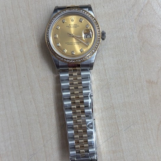 Aftermarket Champagne Diamond Dial for Rolex Datejust Reference 1601: Aftermarket Champagne Diamond Dial for Rolex Datejust Reference 1601 This Rolex Datejust features an aftermarket champagne diamond dial and an aftermarket bracelet. The bezel is aftermarket pave plate