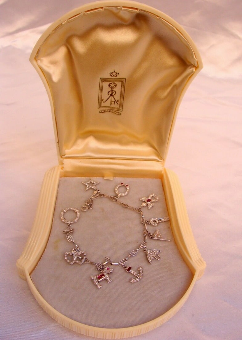 French Art Deco Platinum Diamond Ruby Charm Bracelet with 10 Charms: French Art Deco Platinum Diamond Ruby Charm Bracelet with 10 Charms Discover the elegance of this exquisite French Art Deco charm bracelet, crafted from high-quality platinum (950 parts per 1000). Thi