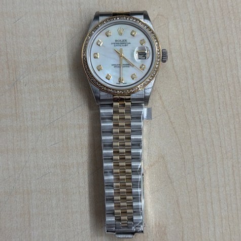 Aftermarket Mother of Pearl Diamond Dial Rolex Datejust Ref 1601: Aftermarket Mother of Pearl Diamond Dial Rolex Datejust Ref 1601 This Rolex Datejust watch features a mother-of-pearl diamond dial with a pave plated diamond bezel. Designed for men, it is identified