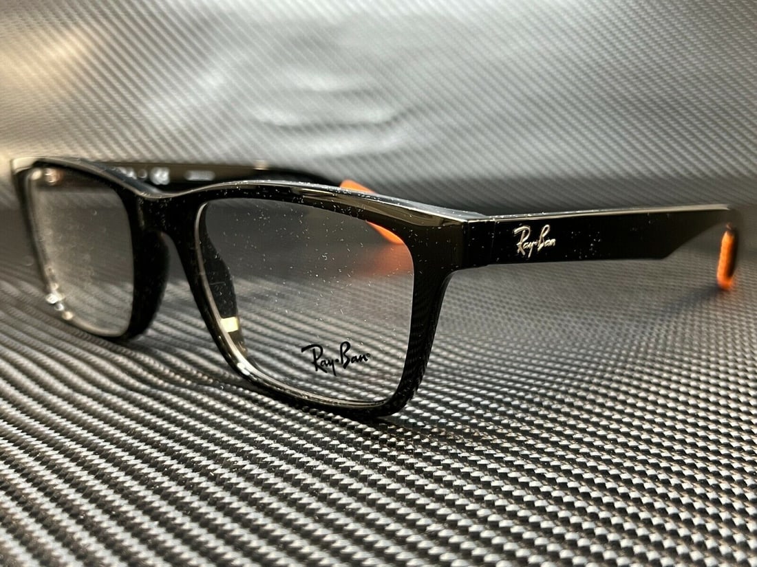 Ray Ban RX7025 5417 Black Square Eyeglasses with Clear Lenses: Ray Ban RX7025 5417 Black Square Eyeglasses with Clear Lenses Discover the stylish and versatile Ray Ban RX7025 5417 eyeglasses, perfect for both men and women. Featuring a sleek black square frame, t