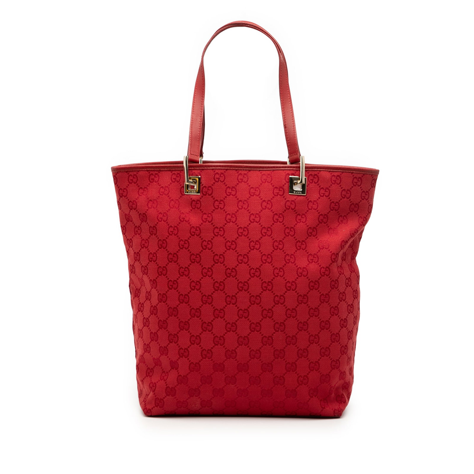 Red GG Canvas Tote Bag by Gucci with Leather Straps: Red GG Canvas Tote Bag by Gucci with Leather Straps This Gucci GG Canvas Tote features a canvas body with flat leather shoulder straps, an open top, and an interior zip pocket. The bag is in red and s