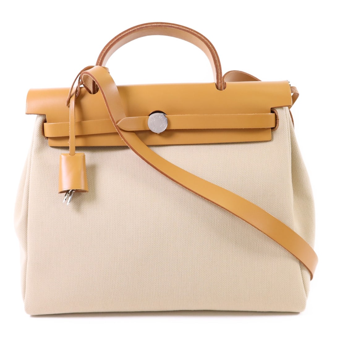 Herbag Canvas Two Way Beige Shoulder Bag with Palladium by Hermes: Herbag Canvas Two Way Beige Shoulder Bag with Palladium by Hermes This Hermes Herbag 2-way shoulder bag features a versatile design crafted from beige canvas. The bag offers both functionality and ele