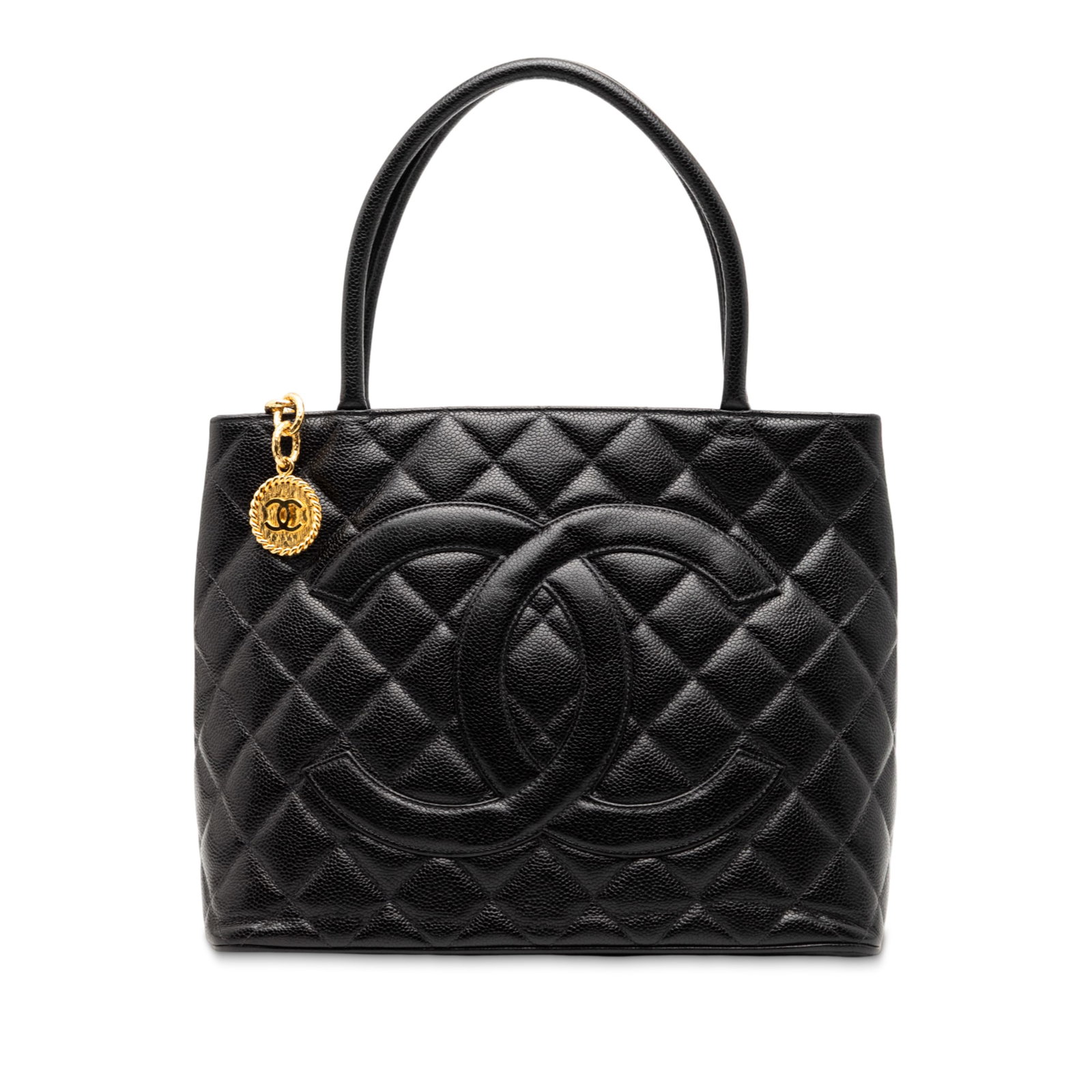 Black Quilted Leather Medallion Tote by Chanel with Top Zip and Back Pocket: Black Quilted Leather Medallion Tote by Chanel with Top Zip and Back Pocket This Chanel Caviar Medallion Tote features a quilted caviar leather exterior in black, rolled leather handles, a top zip clo
