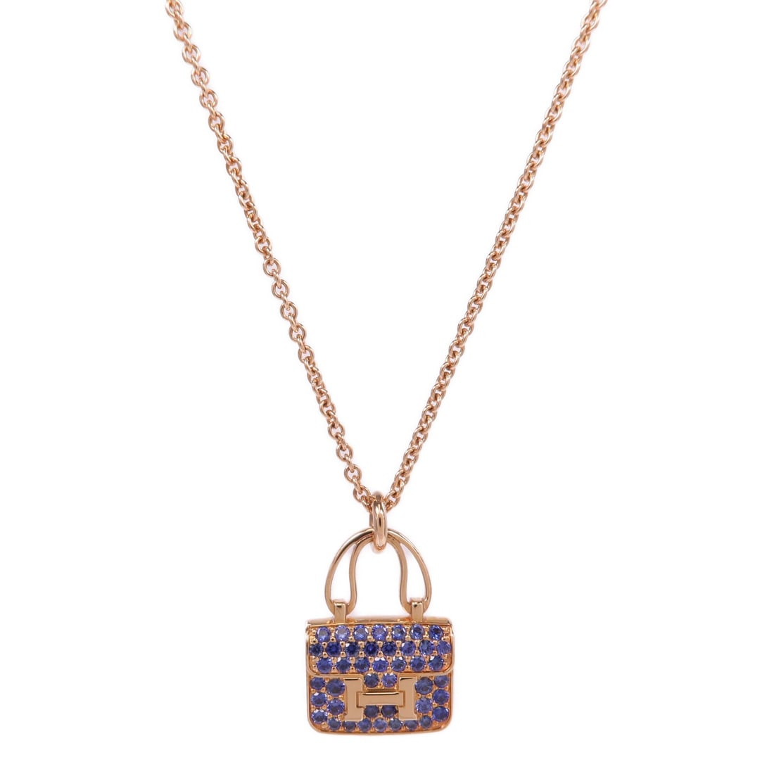 Hermes Constance Amulettes Sapphire Pendant Necklace in 18K Pink Gold: Hermes Constance Amulettes Sapphire Pendant Necklace in 18K Pink Gold This Hermes Amulettes Constance pendant necklace is crafted from 18K pink (rose) gold and features a striking blue sapphire as its