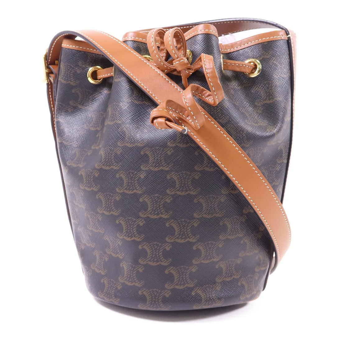 CELINE Triomphe Drawstring Bucket Bag PVC Coated Canvas GHW: CELINE Triomphe Drawstring Bucket Bag PVC Coated Canvas GHW This chic CELINE Triomphe Drawstring Small Bucket Shoulder Bag is crafted from durable PVC coated canvas in a rich brown hue. It features a