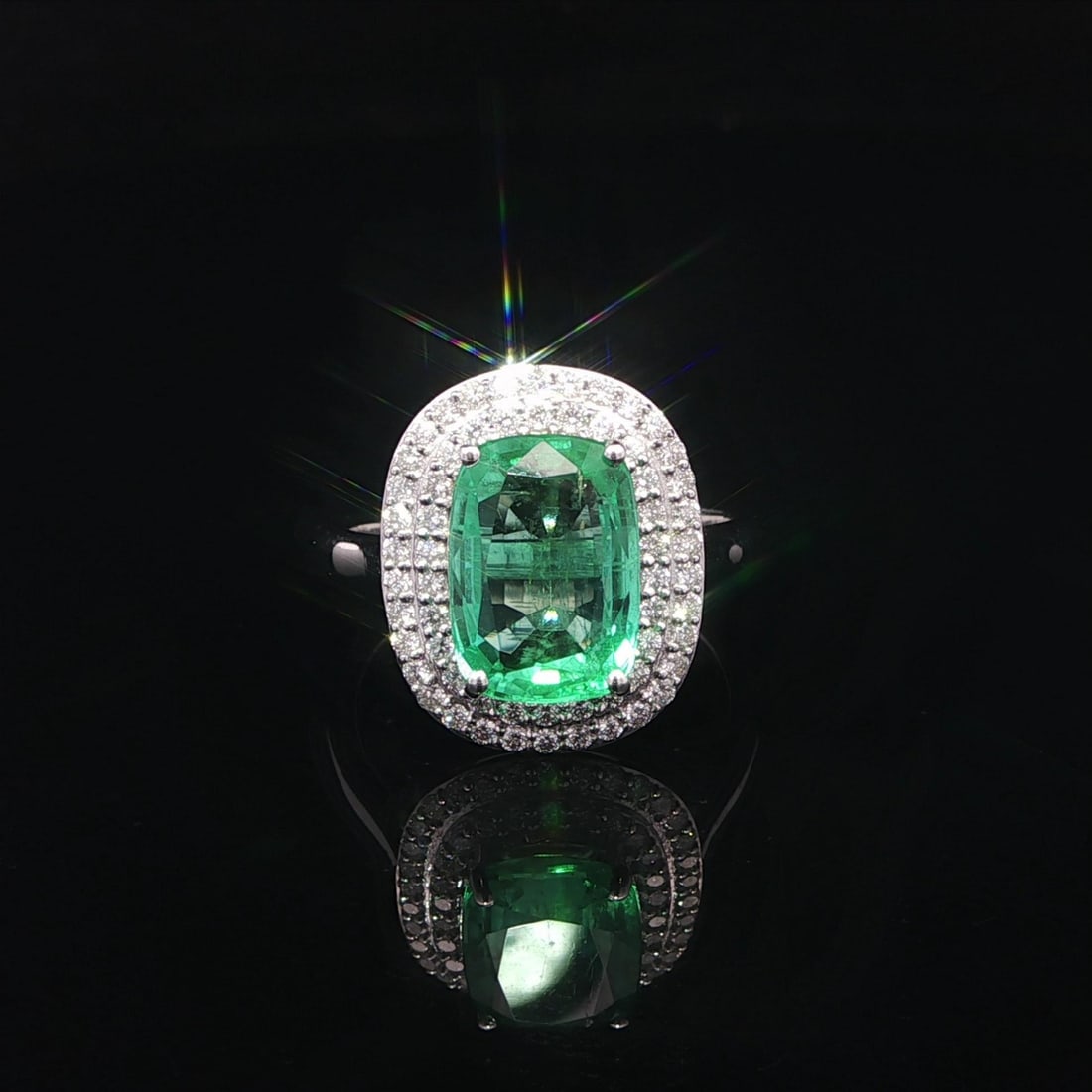 Cocktail Ring 18k White Gold GIA Certified Cushion Emerald Double Halo Diamonds: Cocktail Ring 18k White Gold GIA Certified Cushion Emerald Double Halo Diamonds This cocktail ring features a natural elongated cushion-cut emerald with a mint green color, weighing exactly 3.10 carat
