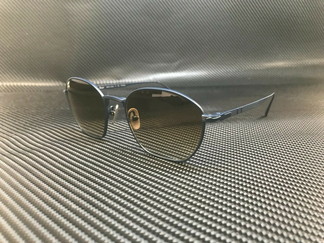 Persol PO5004ST 800251 Navy Blue Round Sunglasses with Gradient Brown Lenses: Persol PO5004ST 800251 Navy Blue Round Sunglasses with Gradient Brown Lenses Elevate your style with these Persol PO5004ST 800251 sunglasses, featuring a contemporary round frame in a sophisticated na