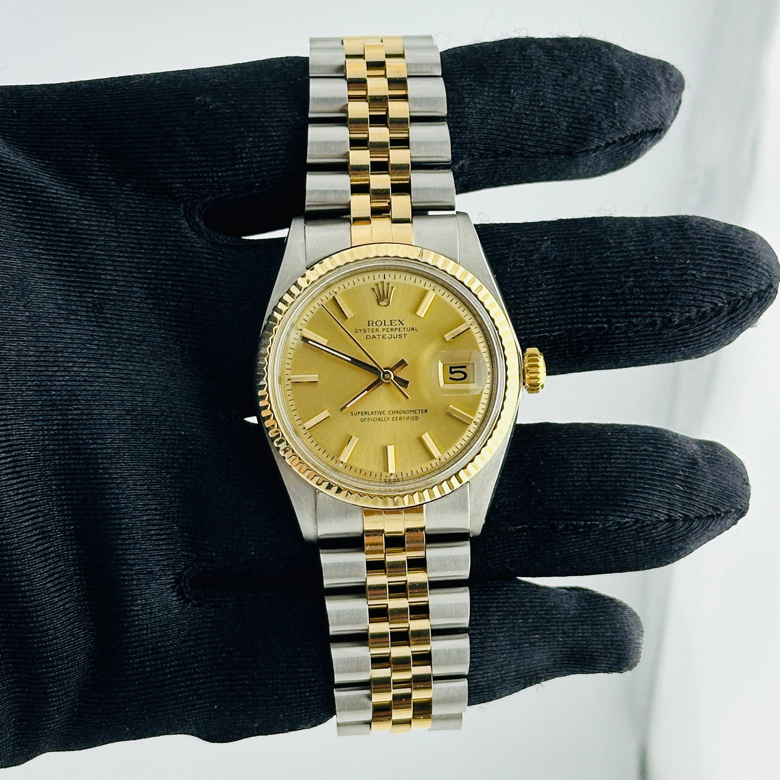 Aftermarket Jubilee Band Datejust Watch Ref 1601 Champagne Stick Dial: Aftermarket Jubilee Band Datejust Watch Ref 1601 Champagne Stick Dial This Rolex Datejust features a black and gold stick dial, complemented by a fluted bezel and an aftermarket Jubilee bracelet. Desi