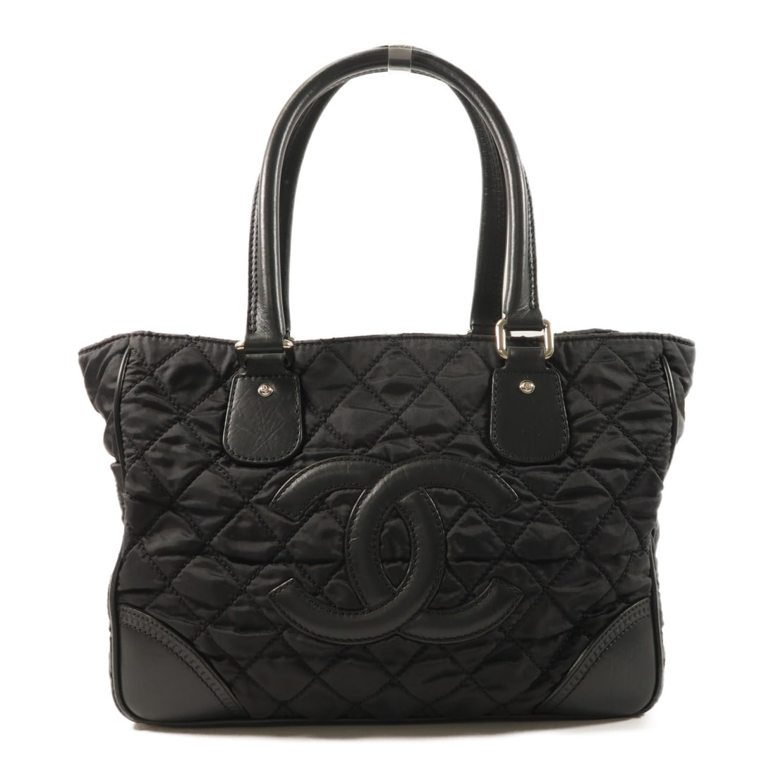 Black Nylon Shoulder Bag by CHANEL with CC Silver Hardware: Black Nylon Shoulder Bag by CHANEL with CC Silver Hardware This CHANEL shoulder bag features a classic black nylon exterior with silver-tone hardware. Designed for women, the bag offers a spacious int