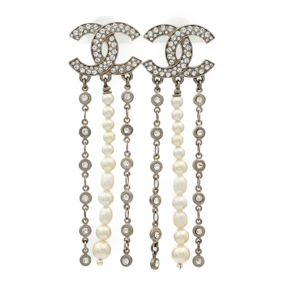 Silver Tone Pierced Earrings by CHANEL with CC Logo: Silver Tone Pierced Earrings by CHANEL with CC Logo These CHANEL CC pierced earrings feature a sleek silver-tone metal design. Crafted in France, they do not include any gemstones and are presented in