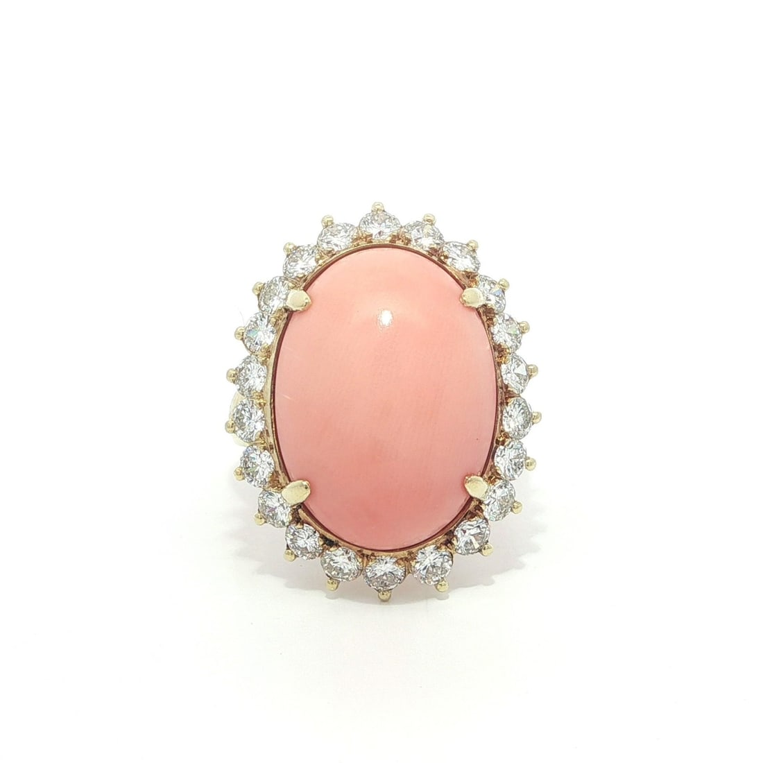 18k Yellow Gold Cocktail Ring With Pink Angel Skin Coral and Diamond Halo: 18k Yellow Gold Cocktail Ring With Pink Angel Skin Coral and Diamond Halo This vintage cocktail ring features an oval cabochon natural angel skin pink coral as the centerpiece, surrounded by a halo of