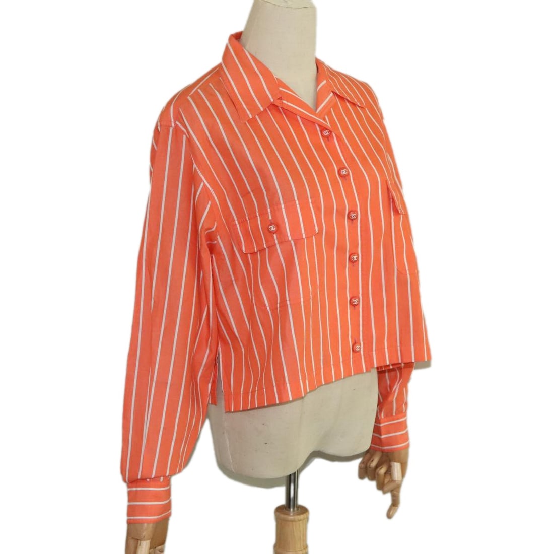 Orange Cotton Shirt by CHANEL for Women France: Orange Cotton Shirt by CHANEL for Women France This CHANEL women's shirt is crafted from cotton in a vibrant orange color. Made in France, it features a classic design with a shoulder width of approxi