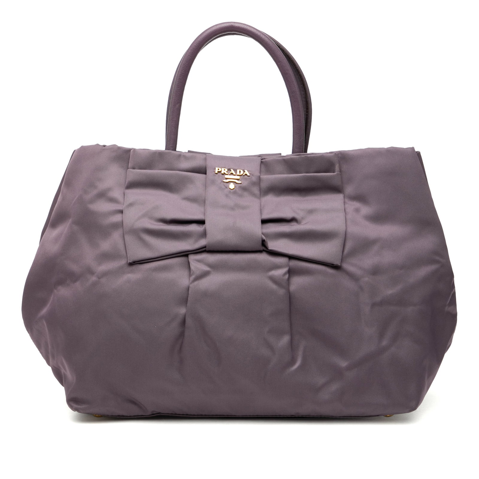 Prada Tessuto Fiocco Purple Nylon Tote Bag with Leather Handles: Prada Tessuto Fiocco Purple Nylon Tote Bag with Leather Handles The Prada Tessuto Fiocco Tote features a durable purple nylon body accented with rolled leather handles. It offers an open top with a ma