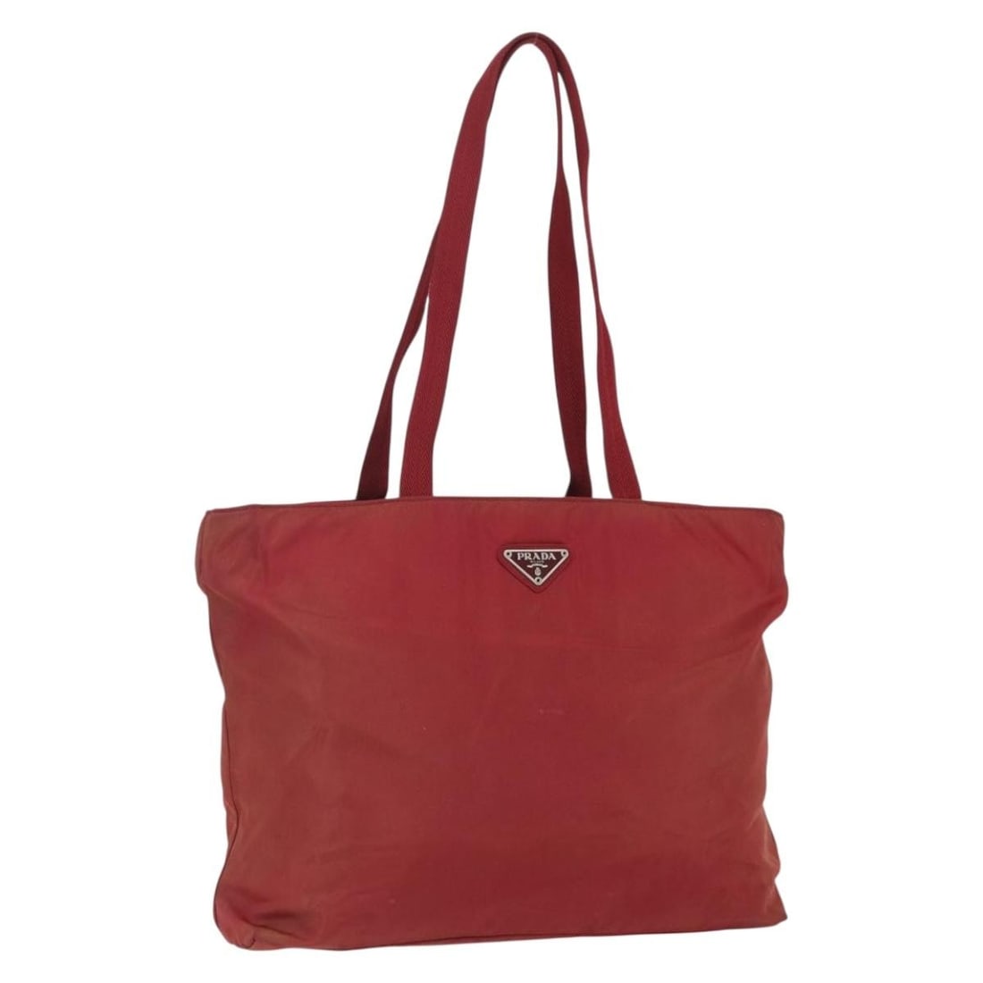Red Nylon Prada Tote Bag Vintage Model 32cm by 26cm by 9cm: Red Nylon Prada Tote Bag Vintage Model 32cm by 26cm by 9cm This vintage Prada tote bag for women is crafted from red nylon with metal fittings. It features ample interior space and pockets, offering f