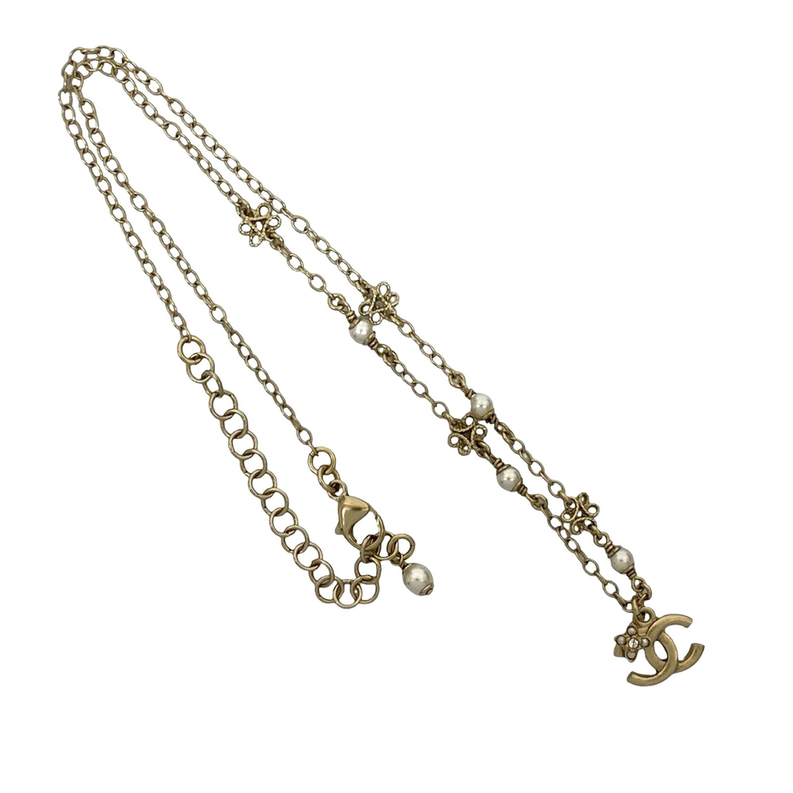 Chanel Flower Station Necklace with Gold Plated CC and Faux Pearls: Chanel Flower Station Necklace with Gold Plated CC and Faux Pearls This Chanel necklace features a gold plated metal body with decorative charms and faux pearl accents. It is designed with a CC pendan