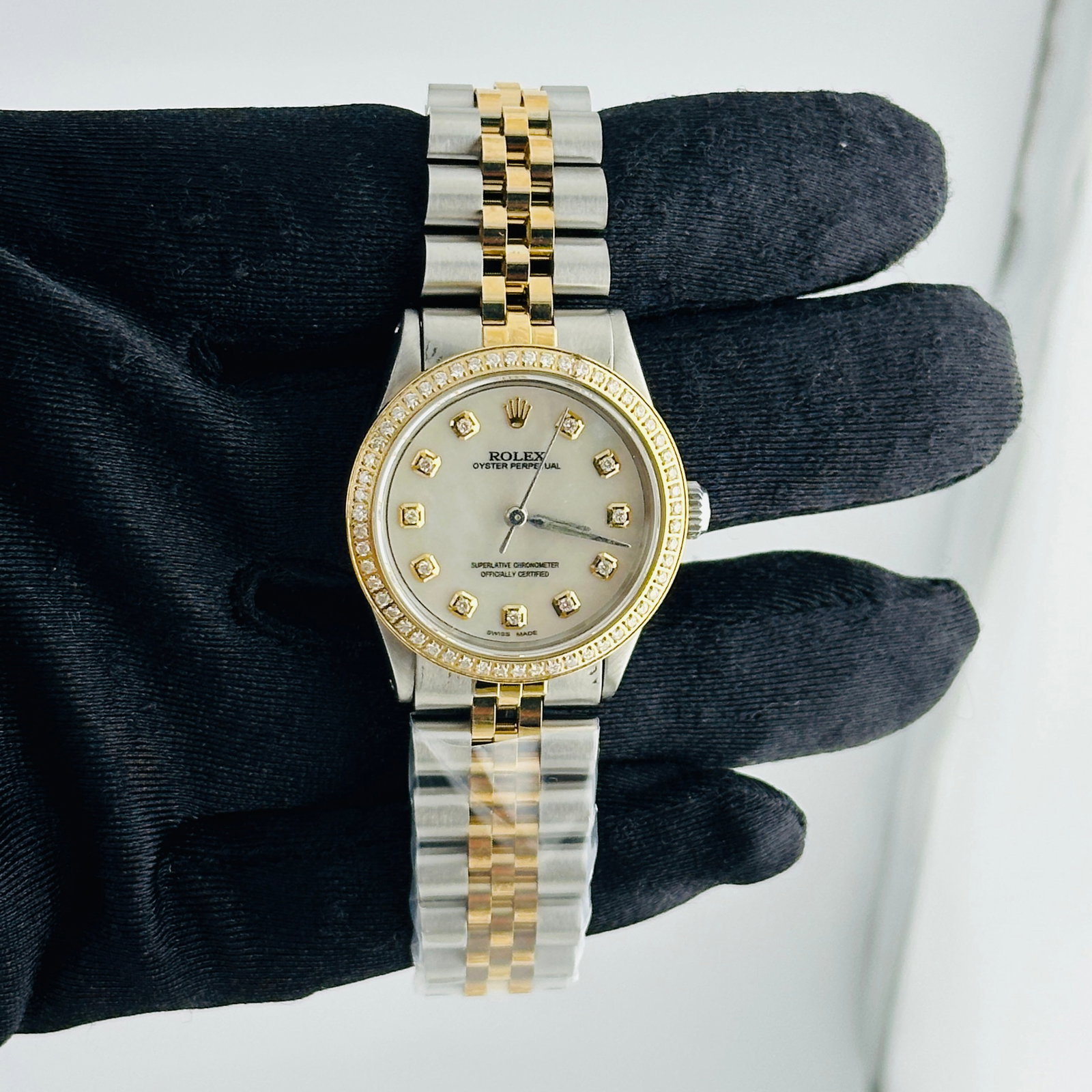 Aftermarket Diamond MOP Dial Rolex Oyster Perpetual Ref 6431 Ladies Watch: Aftermarket Diamond MOP Dial Rolex Oyster Perpetual Ref 6431 Ladies Watch This ladies' Rolex Oyster Perpetual features a white mother of pearl diamond dial and a pave plated diamond bezel. The watch i