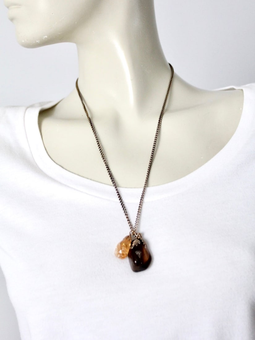 Vintage Silver Tone Necklace with Dark and Amber Stone Pendants: Vintage Silver Tone Necklace with Dark and Amber Stone Pendants This exquisite vintage necklace features two polished stone pendants gracefully dangling from a slender silver-tone chain. The necklace