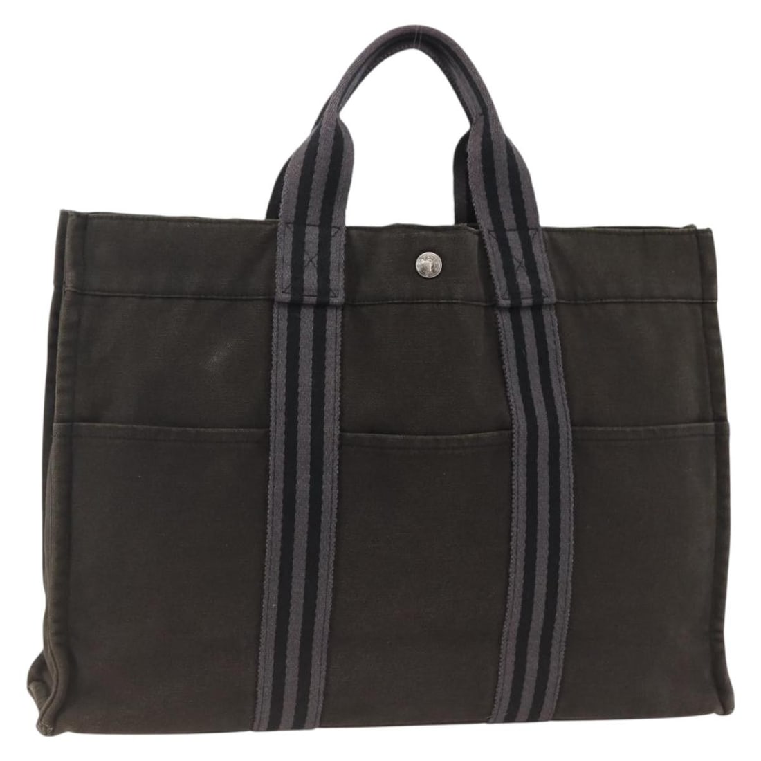 Black Canvas Fourre Tout MM Tote by Hermes France: Black Canvas Fourre Tout MM Tote by Hermes France This Hermes Fourre Tout MM tote bag is crafted from black canvas and designed for women. The bag shows significant signs of use, including loss of sha